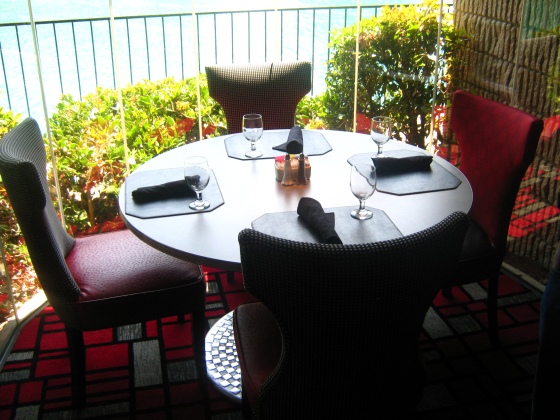 Hilton, Furniture, Table Setting, Red and white chairs, Red and white rug, table beside lake